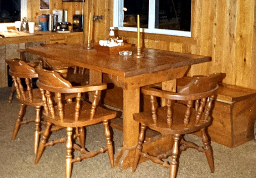 The original table, built from scrap lumber by Fred Logan Bull — we still have it, though it lives elsewhere now. The bench under the window…